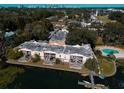 Aerial view of apartments with community pool and lake access featuring docks for water activities at 768 E Michigan St # 75, Orlando, FL 32806