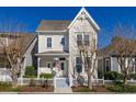 Two-story craftsman style home with American flag and landscaping at 836 Lake Evalyn Dr, Celebration, FL 34747