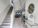 Bright and spacious entryway with staircase and view into the living and dining area at 8939 Zurich Ln, Kissimmee, FL 34747