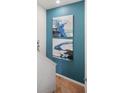 Hallway artistic wall decor with blue abstract artwork, leading to an inviting space at 8976 Azalea Sands Ln # 2604, Davenport, FL 33896