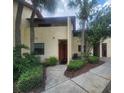 Attractive exterior of home with mature landscaping and sidewalk leading to front door at 10232 Turkey Lake Rd # 180, Orlando, FL 32819