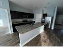 Modern kitchen with granite countertops and stainless steel appliances at 1075 Aerides Way, Davenport, FL 33837