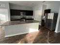 Modern kitchen with granite countertops and stainless steel appliances at 1075 Aerides Way, Davenport, FL 33837