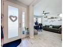 Bright entryway with glass front door and view into a living area at 17863 Passionflower Cir, Clermont, FL 34714
