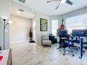 Open living area with tile floors and home office at 17863 Passionflower Cir, Clermont, FL 34714