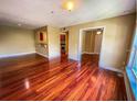 Bright living room with hardwood floors and view into kitchen at 2007 Dixie Belle Dr # 2007 I, Orlando, FL 32812