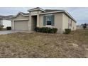 One-story house with a two-car garage and a spacious front yard at 231 Tarpon Bay Blvd, Haines City, FL 33844