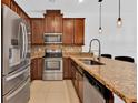 Well-equipped kitchen showcasing stainless steel appliances, granite countertops, and stylish backsplash at 2617 Amati Dr, Kissimmee, FL 34741