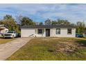Newly renovated home with a white exterior and black accents at 2959 Old Dixie Hwy, Kissimmee, FL 34744