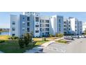 Modern building exterior with lake view and parking at 3131 Paradox Cir # 401, Kissimmee, FL 34746