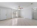 Spacious living room with tile flooring, ceiling fan, and a window offering natural light at 33 W Country Cove Way, Kissimmee, FL 34743