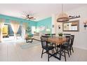 Bright dining area with wooden table and chairs, opens to living room at 4748 Vero Beach Pl, Kissimmee, FL 34746