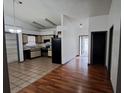 Eat-in kitchen with wood flooring and access to hallway at 56 Buck Cir, Haines City, FL 33844