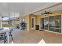Spacious screened lanai with tile flooring, ceiling fan, and sliding door access to the house, ideal for outdoor living at 760 Lake Marion Golf Resort, Poinciana, FL 34759