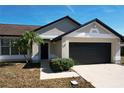 House exterior featuring a two-car garage at 8079 Cloverglen Cir, Orlando, FL 32818