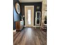 Bright entryway with dark walls, wood flooring, and a full-length mirror at 825 E Lakeshore Blvd, Kissimmee, FL 34744
