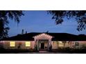 Charming single-story home with a well-manicured lawn at night at 825 E Lakeshore Blvd, Kissimmee, FL 34744