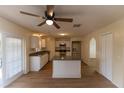 Kitchen features white cabinets, granite countertops, and island at 945 Gateshead Ct, Kissimmee, FL 34758
