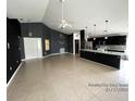 Open living room and kitchen area with high ceilings and tile floors at 1005 Tequesta Trl, Lake Wales, FL 33898