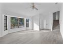 Bright living room featuring hardwood floors and large windows at 10420 Vista Del Sol Cir, Clermont, FL 34711