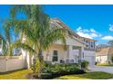 Two-story home with gray siding, white trim, and a three-car garage at 11120 Robert Frost Dr, Winter Garden, FL 34787