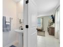 Small bathroom with pedestal sink and white cabinets at 1791 Yellow Trl, Lakeland, FL 33801