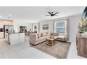 Spacious living room with sectional sofa, coffee table, and large windows at 1791 Yellow Trl, Lakeland, FL 33801
