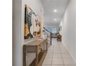 Bright foyer featuring tile flooring, decorative artwork, and an open view into the living area at 2186 Fleming Mist Pl, Kissimmee, FL 34747