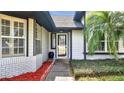 Close up view of the front door with white trim, well manicured landscape, and tasteful accents at 2417 Liela Lee Ct, Ocoee, FL 34761