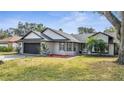 A charming single-story home with a well-manicured lawn, two-car garage, and a delightful yard at 2417 Liela Lee Ct, Ocoee, FL 34761