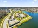 Beautiful aerial view of community pool, lake, and attractive homes on a bright sunny day at 2525 Annacella Ave, Kissimmee, FL 34741