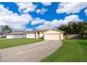 House with a large yard and driveway at 2715 Rismen Ct, Kissimmee, FL 34743