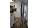 Galley kitchen with stainless steel appliances, granite countertops, and wood-look floors at 2741 N Poinciana Blvd # 43, Kissimmee, FL 34746