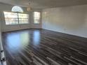Spacious living room featuring wood-look flooring and large windows at 2741 N Poinciana Blvd # 43, Kissimmee, FL 34746