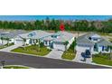 Beautiful birds-eye view of single-Gathering homes with green lawns and brick paved driveways at 306 Hang Loose Way, Daytona Beach, FL 32124