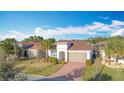 Single-story house, gray garage door, and palm trees at 362 Via Torrente Dr, Kissimmee, FL 34759
