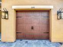 Close up of a garage door with carriage style hardware and decorative lanterns at 3841 Golden Knot Dr, Kissimmee, FL 34746