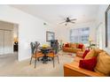 Comfortable living room with neutral carpet, two couches, dining table and ceiling fan for a cozy atmosphere at 4000 San Gallo Dr # 102, Kissimmee, FL 34741