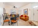 Inviting living area featuring neutral carpet, comfortable seating, a dining table and natural light from the window at 4000 San Gallo Dr # 102, Kissimmee, FL 34741