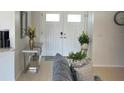Bright and airy entryway with double doors and console table at 509 Drayton Rd, Winter Haven, FL 33884