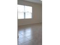 Dining area with tile flooring and a large window at 522 Noble Ave, Davenport, FL 33837