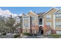 Tan colored building exterior with landscaping and parking at 8301 Elm Park Dr # 634, Orlando, FL 32821
