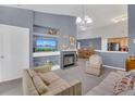 Living room with fireplace, TV, and comfortable seating at 8301 Elm Park Dr # 634, Orlando, FL 32821