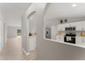 Modern kitchen with white cabinets, stainless steel appliances, and light gray walls at 937 Elkcam Blvd, Deltona, FL 32725