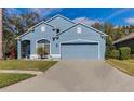 Two-car garage and a nicely landscaped front yard at 9850 Hidden Dunes Ln, Orlando, FL 32832