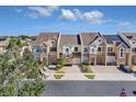 Row of townhouses with solar panels and lush landscaping at 1009 Wood Cv, Kissimmee, FL 34743