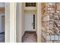 Front entry with a white door and brick columns at 1009 Wood Cv, Kissimmee, FL 34743