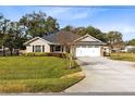 Charming one story home with an attached two-car garage and well manicured lawn at 1150 Eden Dr, St Cloud, FL 34771
