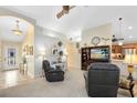Inviting living room with neutral tones, arched doorway, ceiling fan, and an entertainment center, creating a cozy and stylish space at 1150 Eden Dr, St Cloud, FL 34771