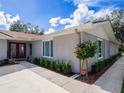 Beautiful single-story home featuring a new paint color, manicured yard, and a red front door at 123 Lakeview Dr, Auburndale, FL 33823